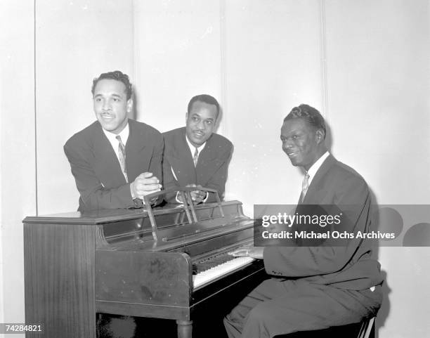 Bassist Johnny Miller, pianist Nat 'King' Cole and guitarist Oscar Moore of the "Nat 'King' Cole Trio" record in Capitol Records studios on December...
