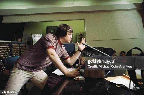 Singer and mastermind Brian Wilson of the rock and roll band "The Beach Boys" directs from the control room while recording the album "Pet Sounds" in...