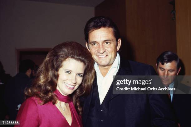 Married country singers Johnny Cash & June Carter Cash pose for a portrait at an event in September 1969 in California.