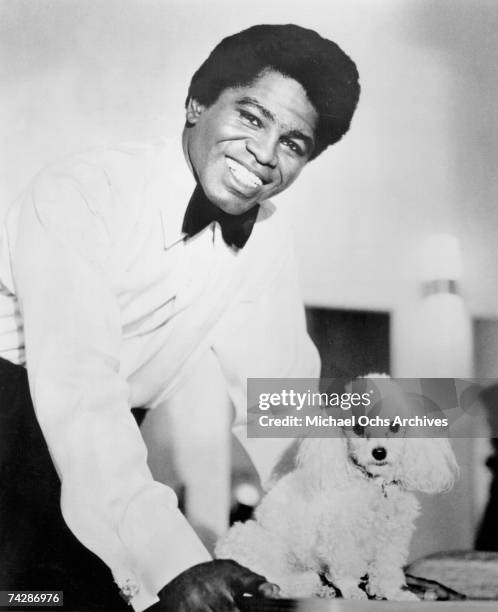 'Godfather of Soul' James Brown poses for a portrait with a toy poodle in 1960 in New York, New York.