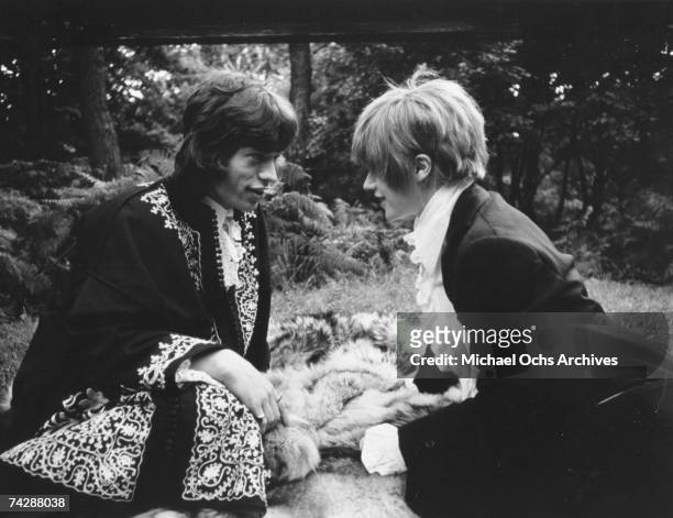 Singer Mick Jagger and his girlfriend singer Marianne Faithfull pose for a portrait in a park in 1968 in London, England.