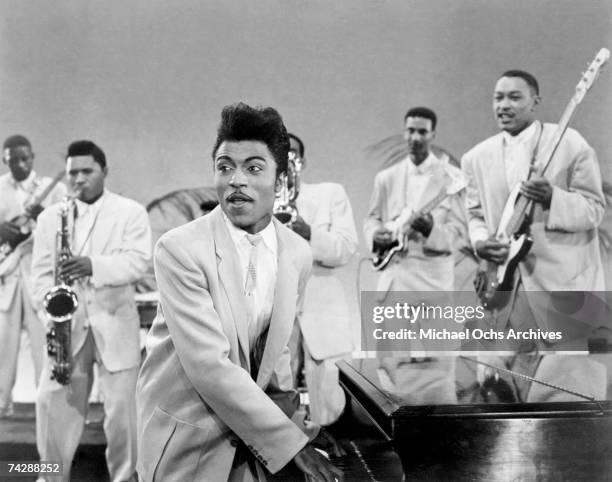 Musician Little Richard performs onstage with his band as his saxophone player Grady Gaines stands on the piano in circa 1957 in scene from the movie...