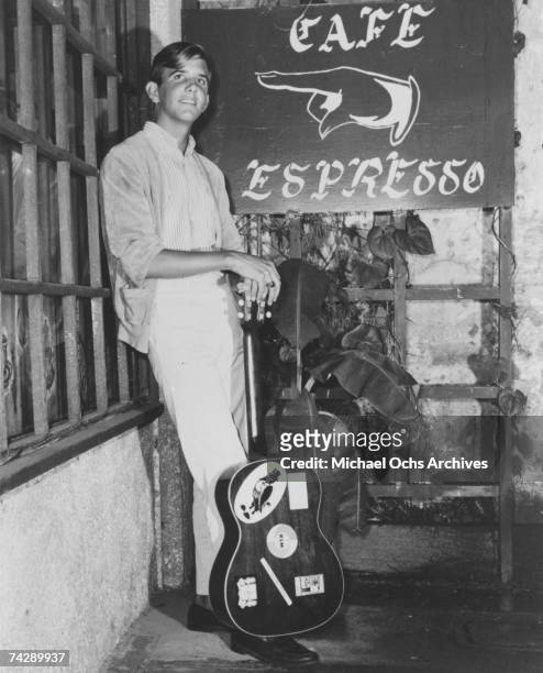 Singer/songwriter Gram Parsons poses for a portrait outside the Cafe Espresso in circa 1965 in Portland, Oregon.