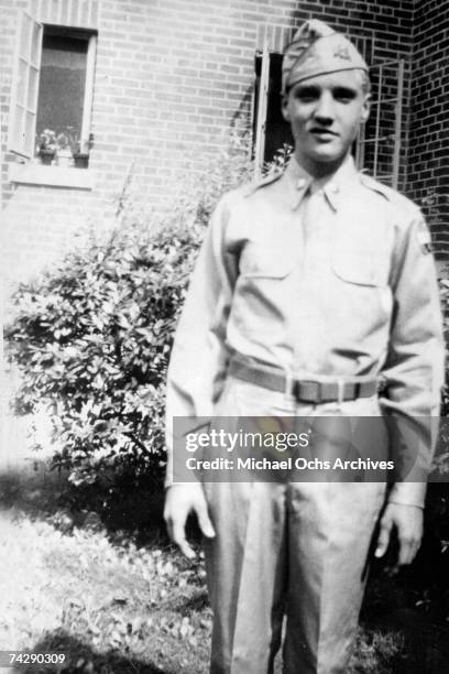 Rock and roll singer Elvis Presley poses for a portrait wearing his high school army ROTC uniform in 1955 in Memphis, TN.