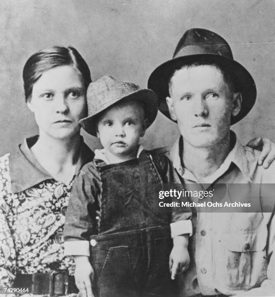 Rock and roll singer Elvis Presley poses for a family portrait with his parents Vernon Presley and Gladys Presley in 1937 in Tupelo, Mississippi.