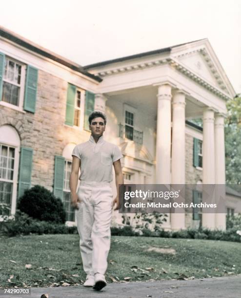 Rock and roll singer Elvis Presley strolls the grounds of his Graceland estate in circa 1957.