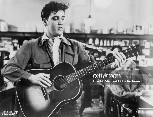 Rock and roll singer Elvis Presley in a movie still from circa 1957.