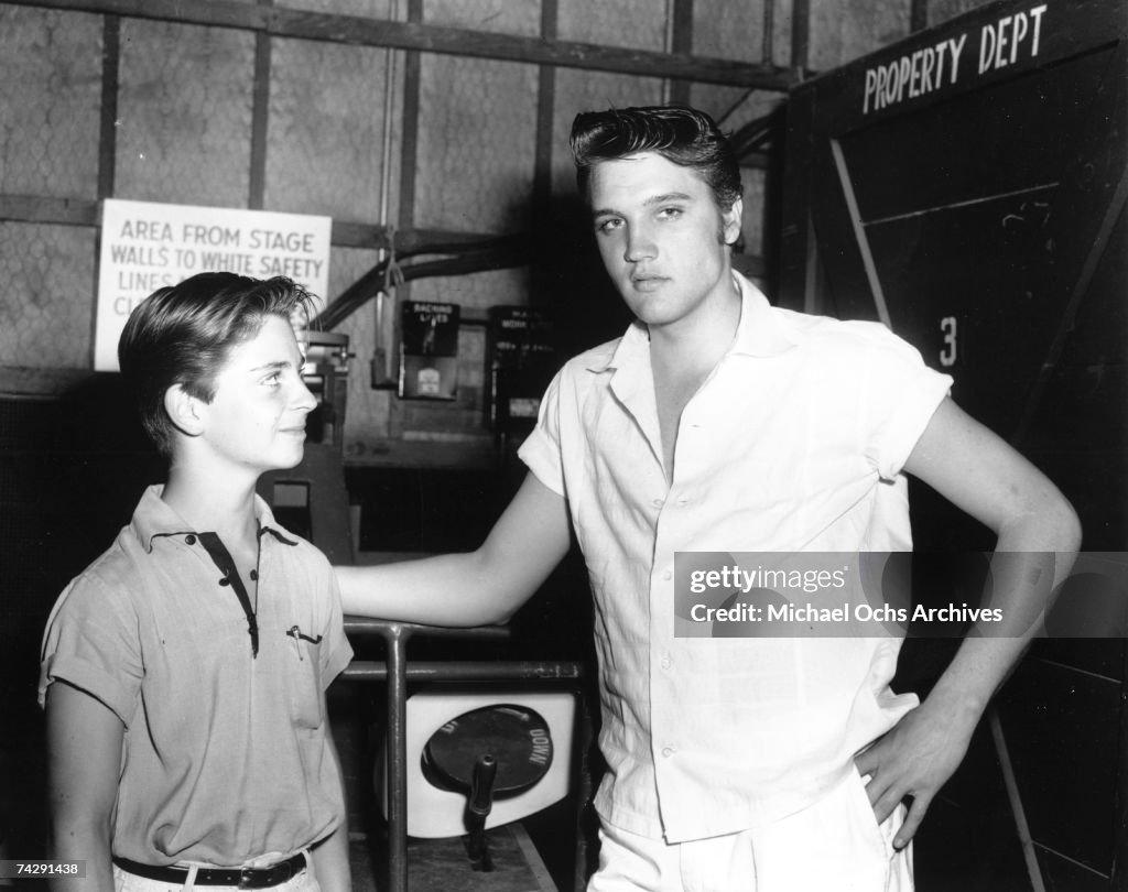 Elvis Presley with a fan behind the scenes