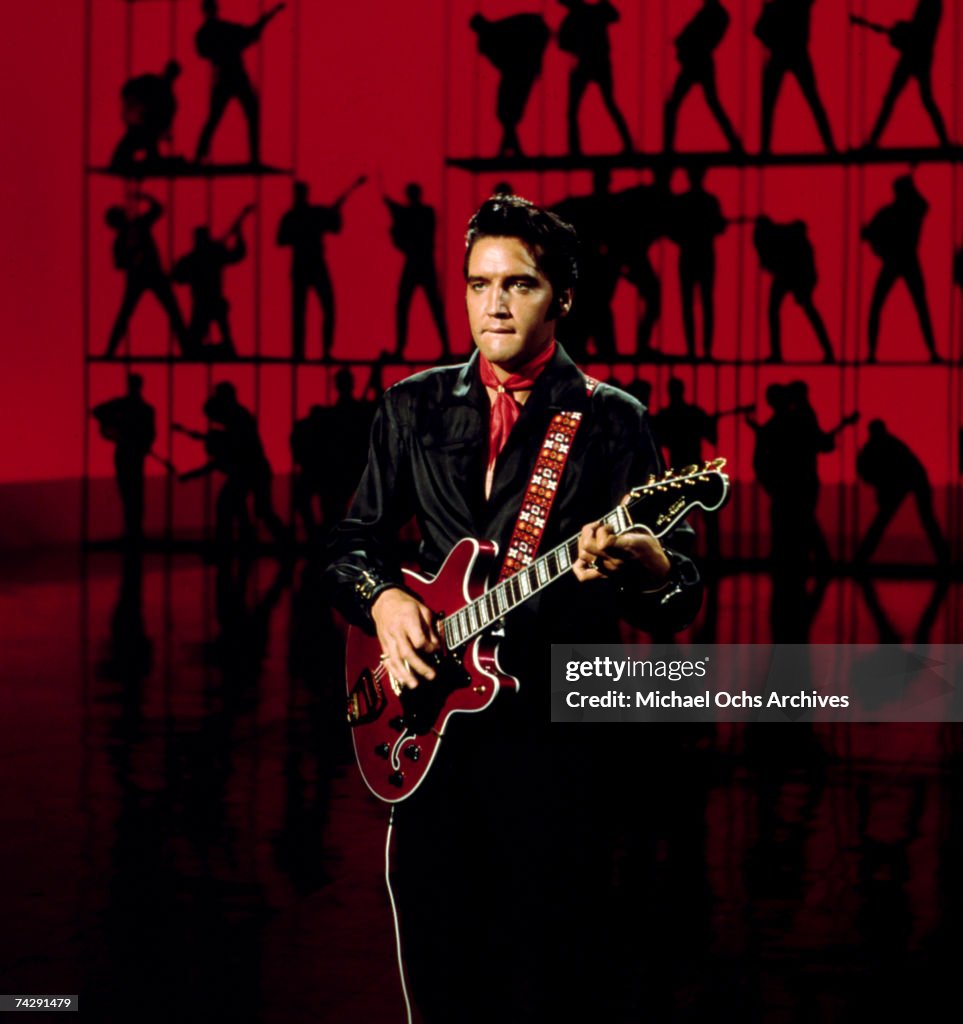 Rock and roll musician Elvis Presley performing...