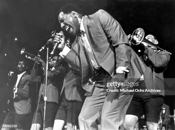 Soul singer Otis Redding passionately sings with his horn section behind him as he performs onstage in 1967.