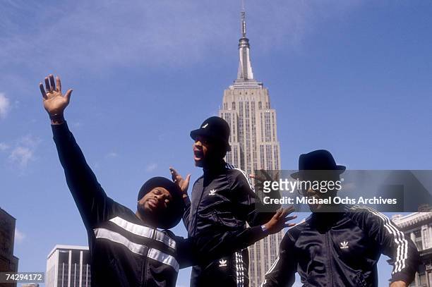 Joseph Simmons, Darryl McDaniels and Jam Master Jay of the hip-hop group "Run DMC" pose for a portrait session wearing Addidas sweat suits in front...