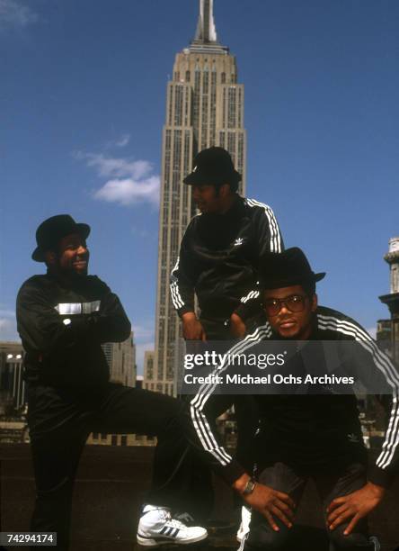 Joseph Simmons, Darryl McDaniels and Jam Master Jay of the hip-hop group "Run DMC" pose for a portrait session wearing Addidas sweat suits in front...