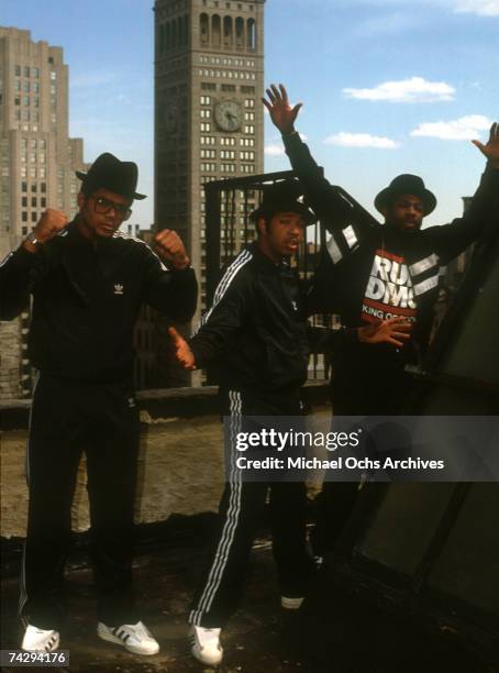 Joseph Simmons, Darryl McDaniels and Jam Master Jay of the hip-hop group "Run DMC" pose for a portrait session wearing Addidas sweat suits in front...