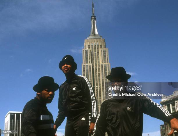 Joseph Simmons, Darryl McDaniels and Jam Master Jay of the hip-hop group "Run DMC" pose for a portrait session wearing Addidas sweat suits in front...