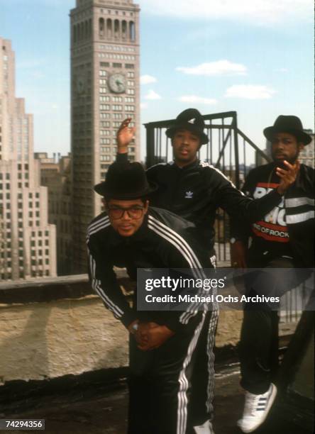 Joseph Simmons, Darryl McDaniels and Jam Master Jay of the hip-hop group "Run DMC" pose for a portrait session wearing Addidas sweat suits in front...