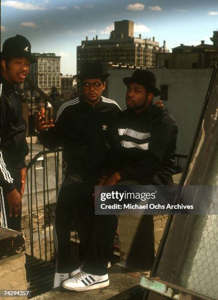 Joseph Simmons, Darryl McDaniels and Jam Master Jay of the hip-hop group "Run DMC" pose for a portrait session wearing Addidas sweat suits in front...