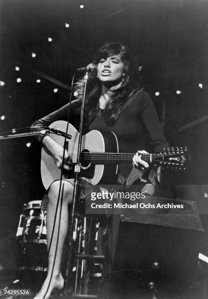 Singer/songwriter Carly Simon performs onstage with a Guild 12-string acoustic guitar in circa 1972.