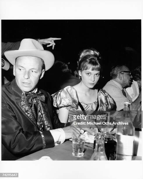 Singer and actor Frank Sinatra and actress Mia Farrow attend the SHARE Boomtown benefit party in 1965 in Los Angeles, California.