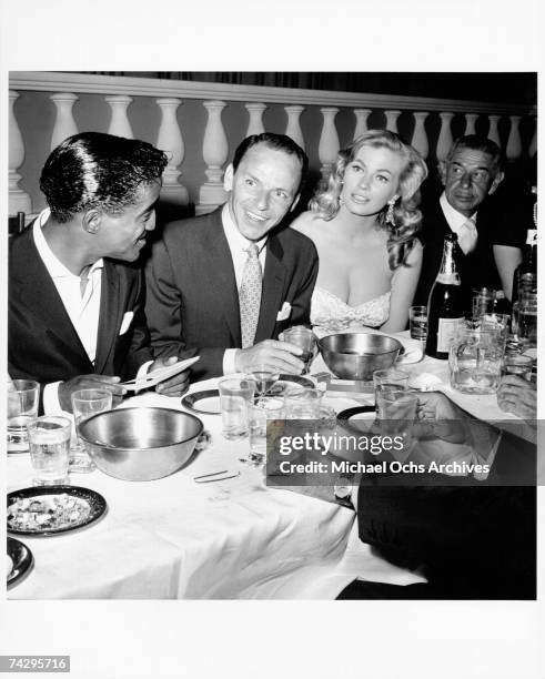 Singer and member of the Rat Pack Sammy Davis Jr., Frank Sinatra, actress Anita Ekberg and restauranteur Mike Romanoff dine at Romanoff's Restaurant...