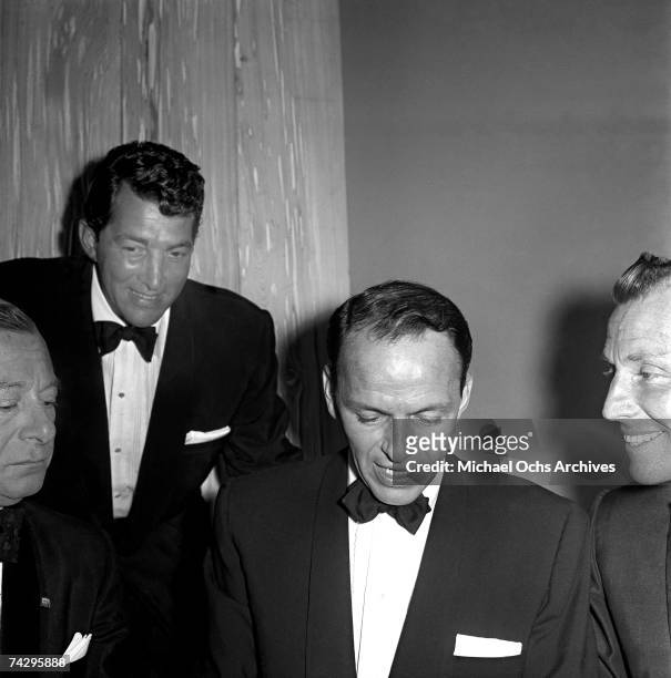 Singers and Rat Pack members Frank Sinatra and Dean Martin attend a Friar's Club dinner on February 14, 1957 in Los Angeles, California.