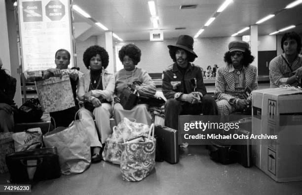 Singer Sly Stone of the psychedelic soul group "Sly & The Family Stone" awaits transportation with his actual family including his parents on August...