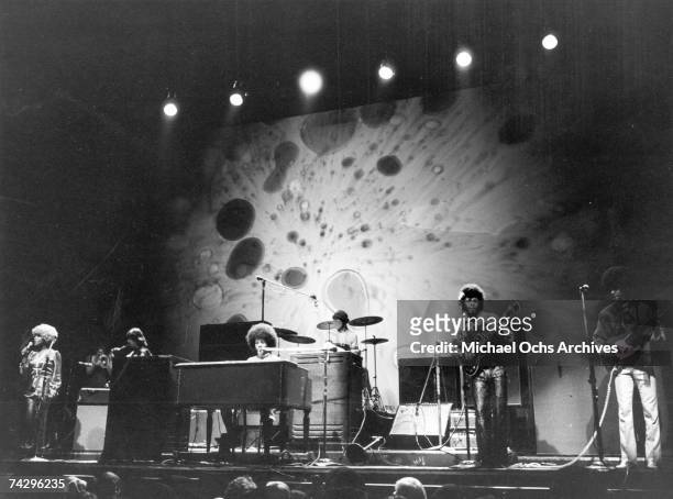 Psychedelic soul group "Sly & The Family Stone" perform onstage in front of a psychedelic light show backdrop. Rosie Stone, Jerry Martini, Sly Stone,...