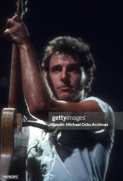 Rocker Bruce Springsteen holds his Fender Telecaster electric guitar up as he performs onstage in circa 1975.