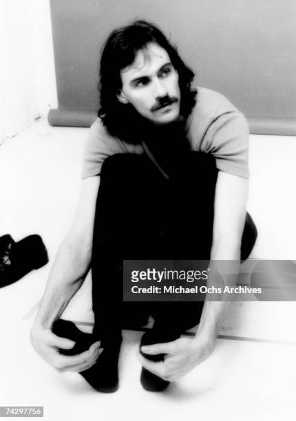 Singer/songwriter James Taylor poses for a portrait holding a pocket watch in circa 1976.