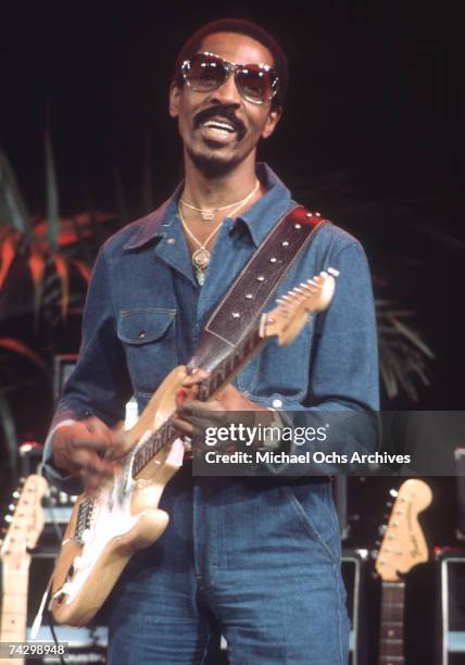 Rock and roll musician Ike Turner performs onstage with a Fender Stratocaster electric guitar, circa 1972.