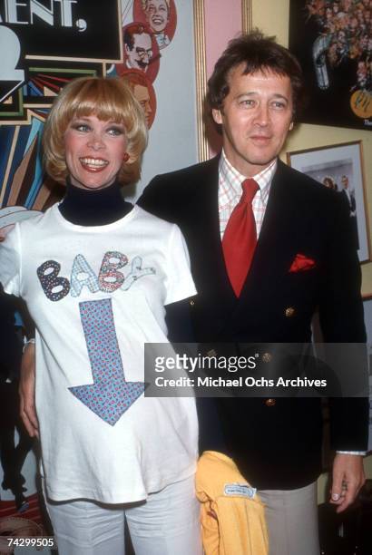 Entertainers Bobby Van and his pregnant wife Elaine Joyce wearing a shirt that reads "Baby" with an arrow pointing down towards her belly pose for a...