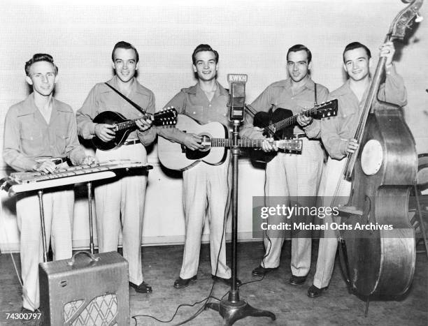 Country music duo The Wilburn Brothers Virgil Doyle Wilburn and Thurman Theodore "Teddy" Wilburn 2nd from left) pose with their band st radio station...
