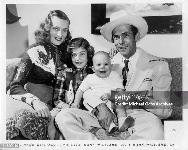 The Williams family Left to Right Audrey Williams, Lycretia Williams, Hank Williams Jr and Hank Williams Sr pose for a portrait in 1949 in Nashville...
