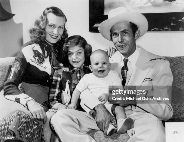 The Williams family Left to Right Audrey Williams, Lycretia Williams, Hank Williams Jr and Hank Williams Sr pose for a portrait in 1949 in Nashville...