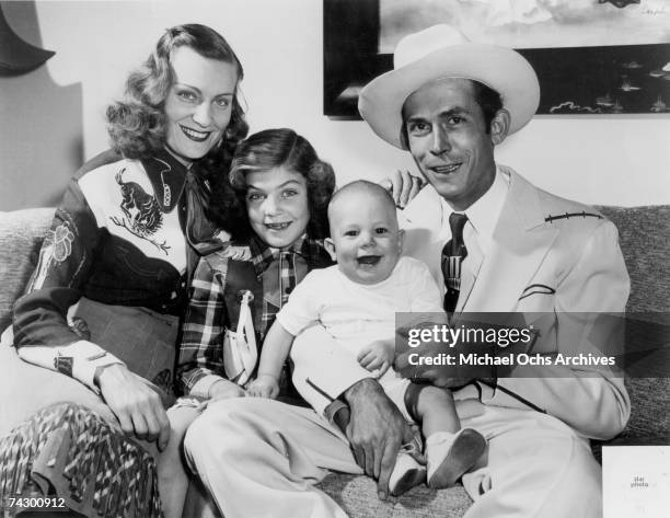 The Williams family Left to Right Audrey Williams, Lycretia Williams, Hank Williams Jr and Hank Williams Sr pose for a portrait in 1949 in Nashville...