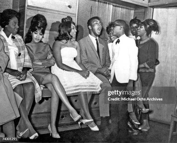 Motown star Stevie Wonder is joined by heavyweight champion Muhammad Ali Ronnie Spector and Dionne Warwick backstage circa 1964.