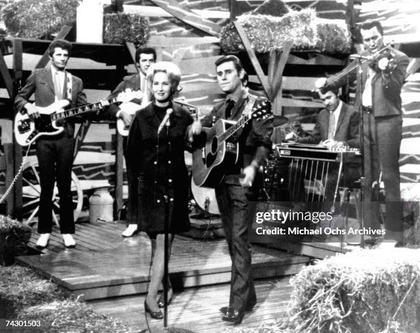 Tammy Wynette and George Jones Perform on stage with the Jones Boys in circa 1972.