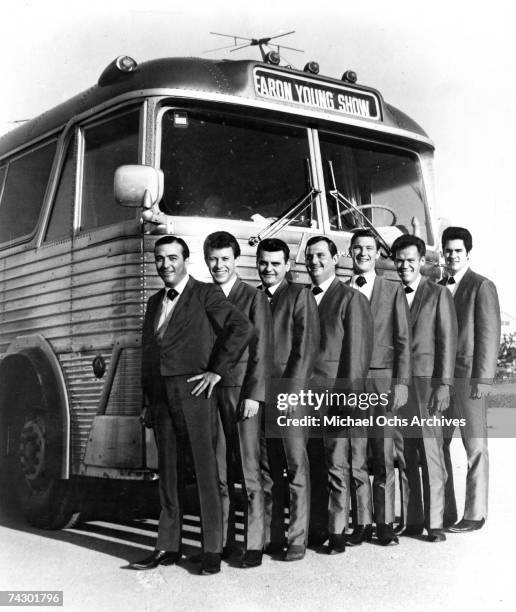 Country singer Faron Young and his band pose for a publicity still in front of their tour bus circa 1965.