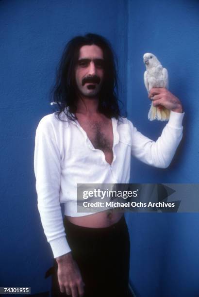 Rock and roll guitarist Frank Zappa poses for a portrait holding a pet bird in April 1979 in Los Angeles, California.