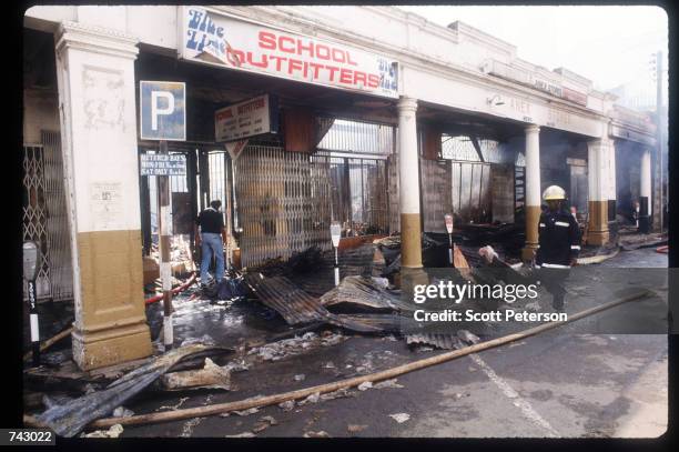 Fireman walks by the remains of an Asian-owned building that was destroyed by arson April 20, 1992 in Nairobi, Kenya. Incited by President Moi,...