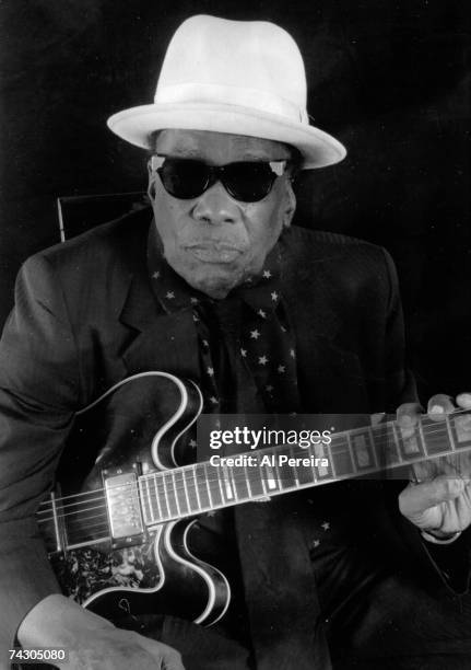 Musician John Lee Hooker appears in a portrait with his Epiphone Guitar taken in his home on March 20, 1995 in Long Beach, California.