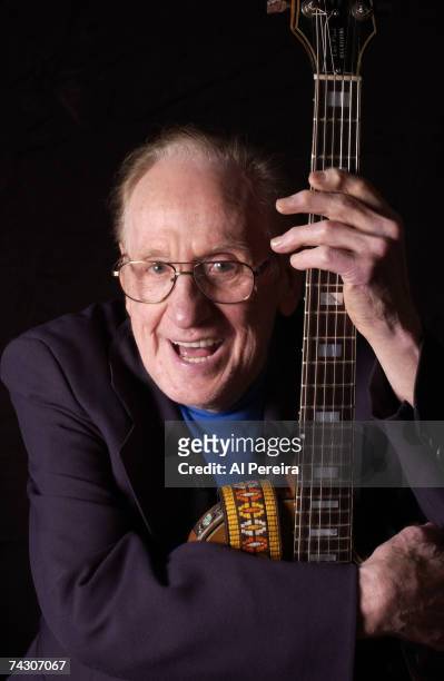 Guitarist and inventor Les Paul poses for a portrait with the guitar that he invented in circa 2000 in New York City, New York.