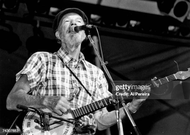 Pete Seeger performs at a tribute concert to Harry Chapin, who died one year earlier, on July 16, 1982 at Pier 84 in New York City.