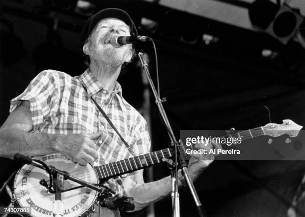 Pete Seeger performs at a tribute concert to Harry Chapin, who died one year earlier, on July 16, 1982 at Pier 84 in New York City.