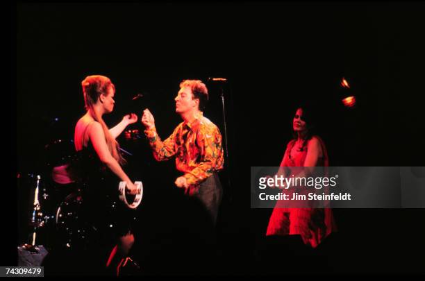 Cindy Wilson, Fred Schneider and Kate Pierson of the rock and roll band the "B-52's" perform onstage in 1990 in Minnesota.