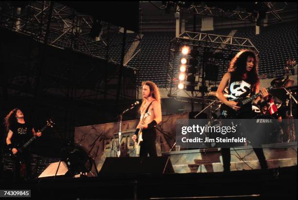 Bassist Jason Nestwed, singer and guitarist James Hetfield and guitarist Kirk Hammett of the heavy metal quartet Metallica performs onstage in 1988...