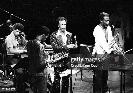Jazz saxophonist Ornette Coleman performs onstage with fellow musicians in circa 1975.