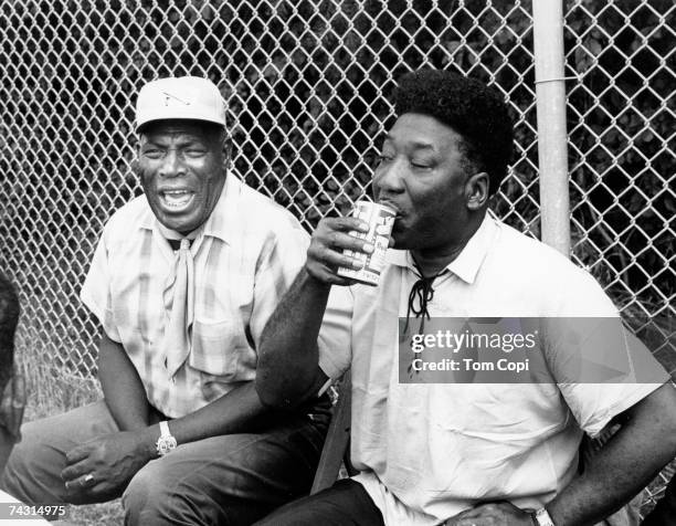 Blues Guitarists and singers Muddy Waters and Howlin' Wolf relax backstage at the Ann Arbor Blues Festival in August 1969 in Ann Arbor, Michigan.