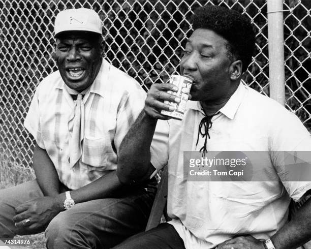 Blues Guitarists and singers Muddy Waters and Howlin' Wolf relax backstage at the Ann Arbor Blues Festival in August 1969 in Ann Arbor, Michigan.