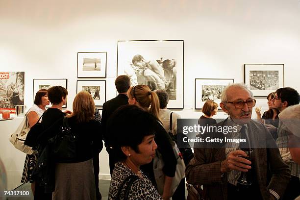 Photographer Thurston Hopkins talks to guests at the Getty Images Gallery during the private view of the Picture Post exhibition on May 24, 2007 in...