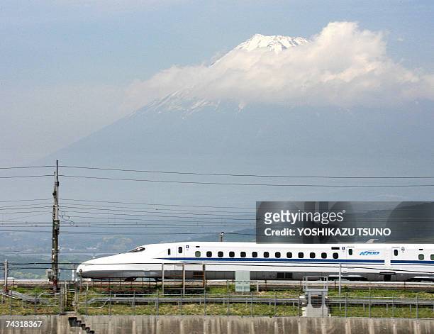 Japan Railway Tokai's new bullet train "Shinkansen N700" speeds before Mount Fuji during a test run in Shizuoka prefecture, central Japan 23 May...